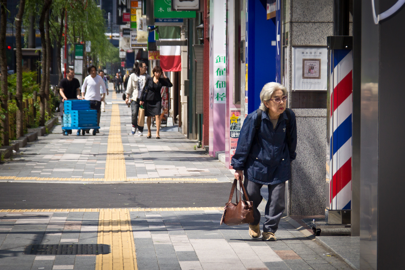 Elderly woman on sidewalk; Ginza, Tokyo