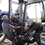Public domain photo of roughnecks at an oil well, by NIOSH