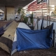 Homeless tents and flag under CA-87 in San Jose