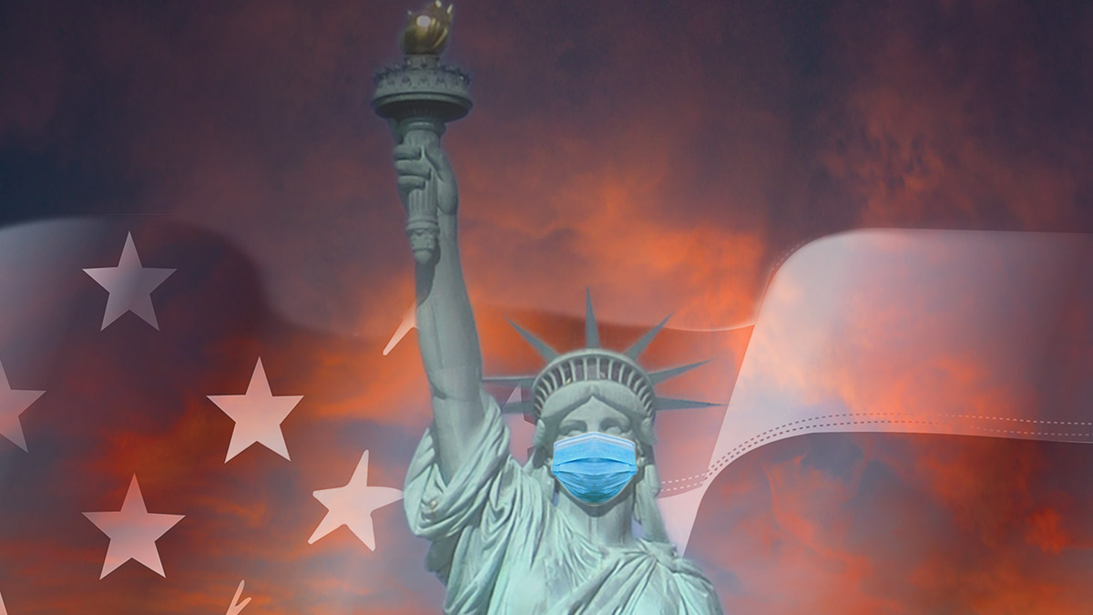 Lady Liberty under dramatic skies, with a face mask