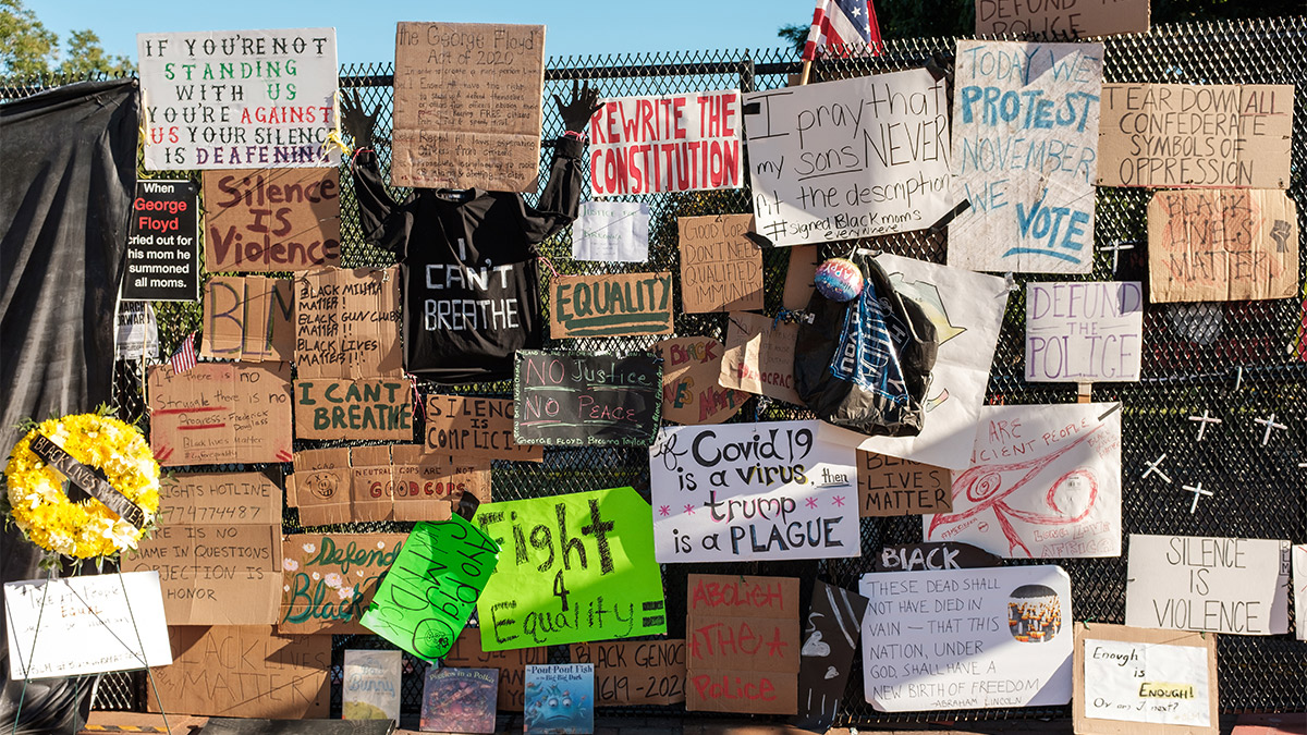 Protest signage at the White House fence