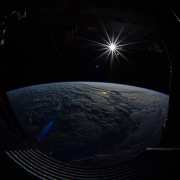 The sun, seen over earth from the International Space Station