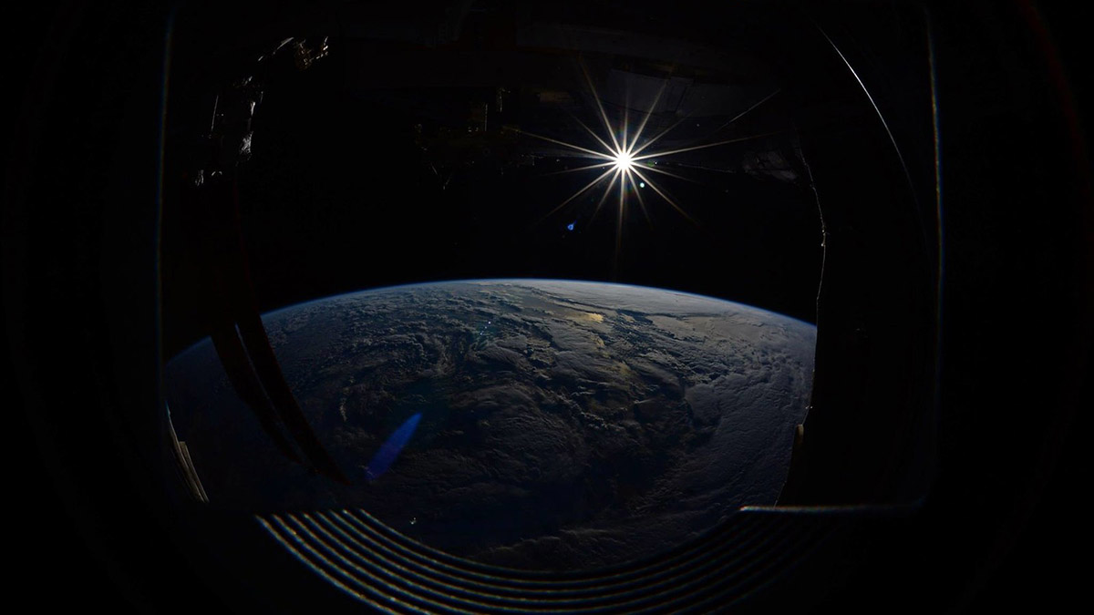 The sun, seen over earth from the International Space Station