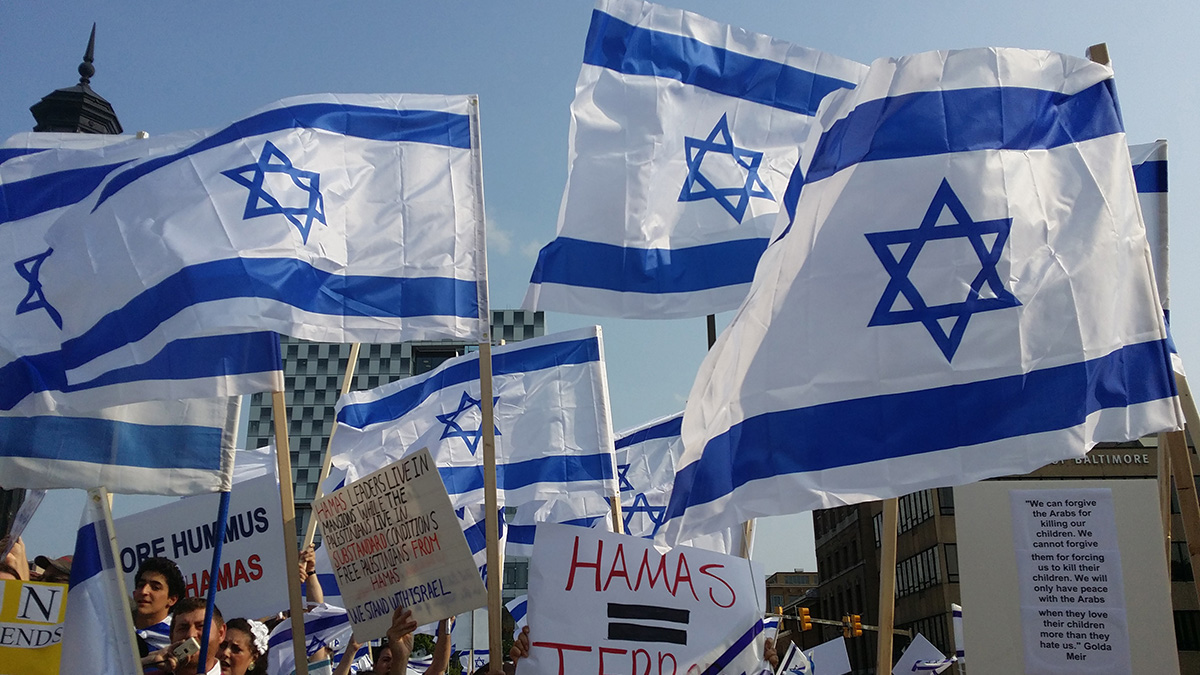 Pro-Israel protestors carry Israel national flags