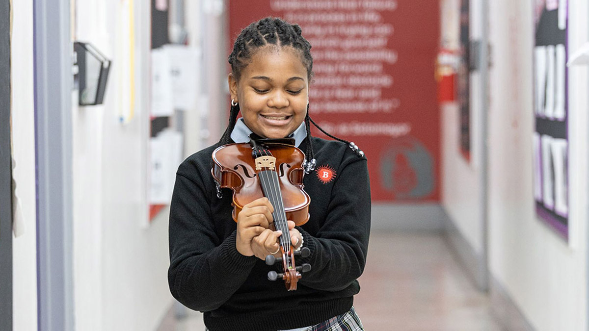 A music student at Seton Education Partners, which runs 21 schools in New York, California, and Cincinnati that reflect Catholic values but operate independently of the Catholic Church.
