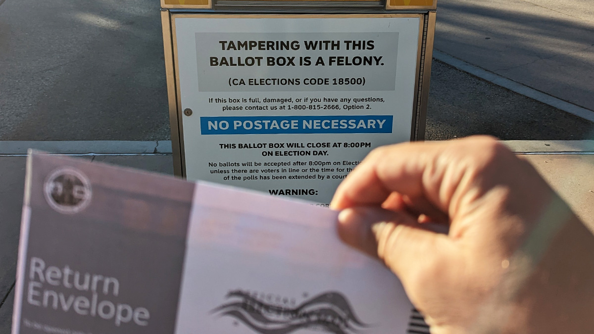 A California voter approaches a ballot box to drop off his ballot.