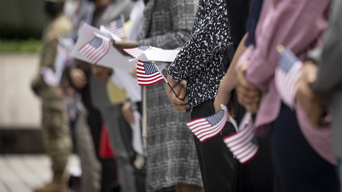 Immigrants become U.S. citizens in a naturalization ceremony