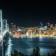 View across a bridge towards downtown San Francisco at night.